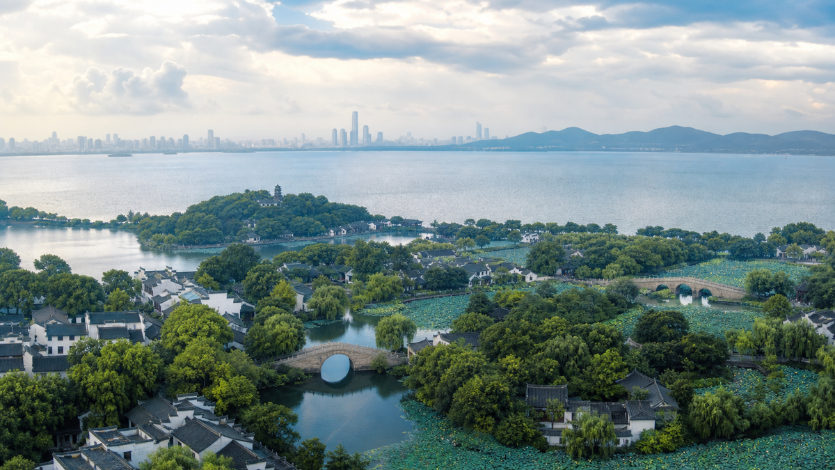 Wuxi overview in summer with lake, lotus gardens and green landscape